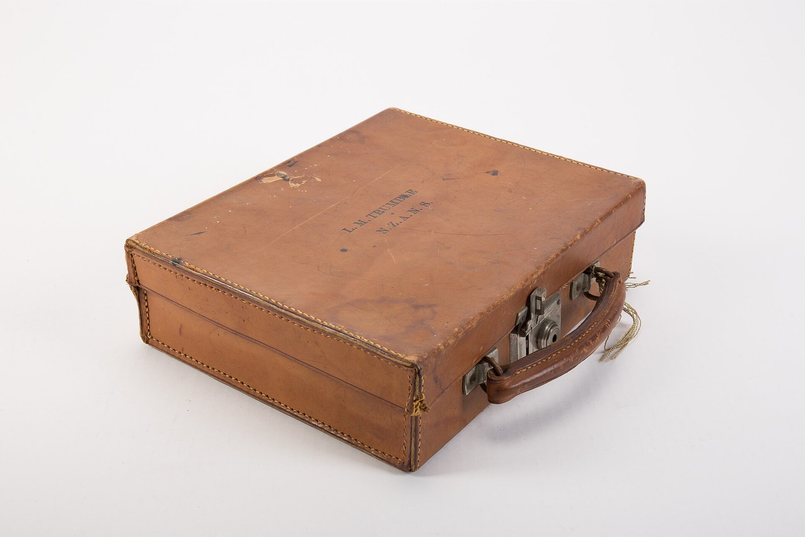 Small tan leather suitcase